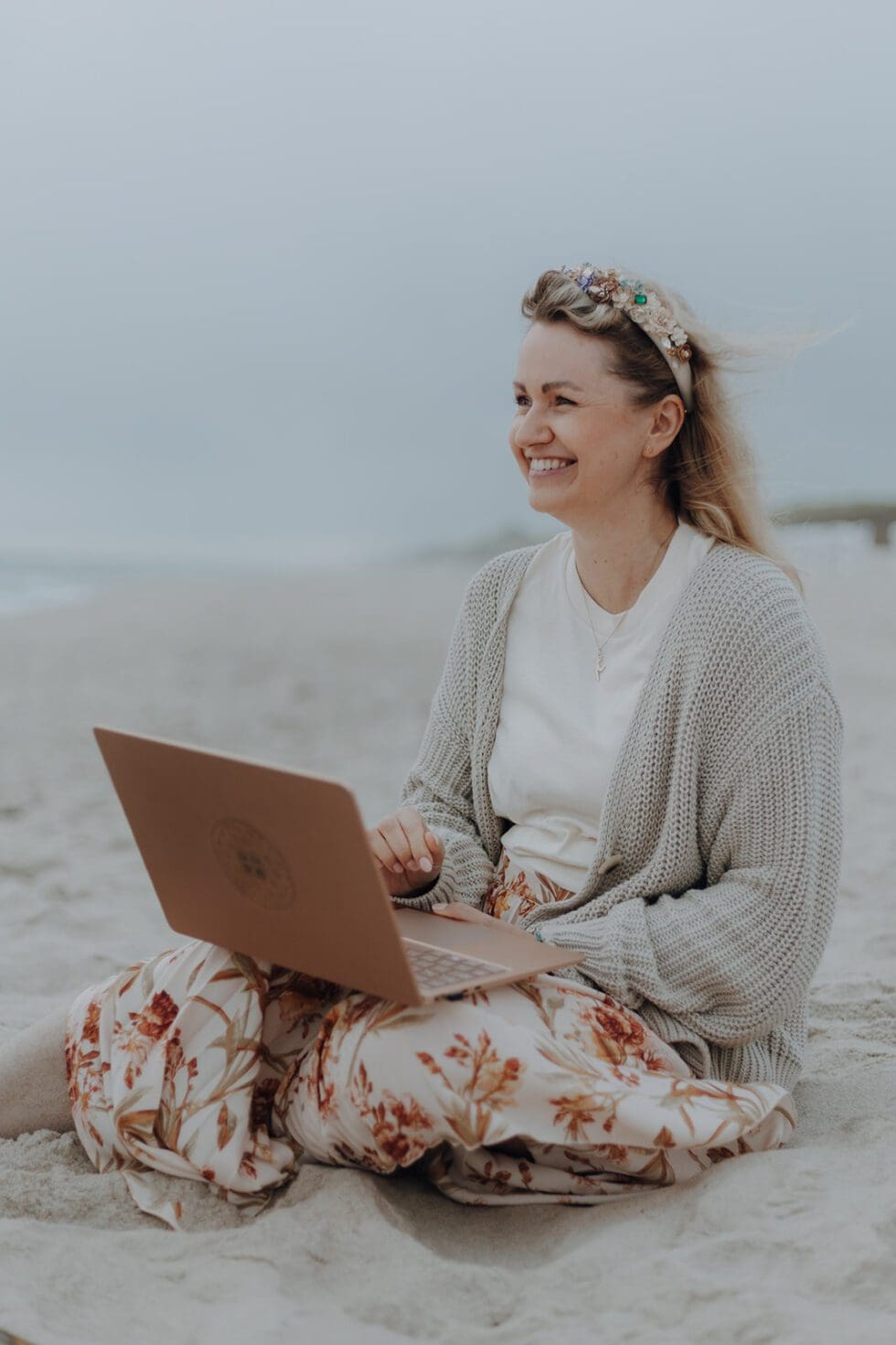 Ann-Kristin Chus sitzt mit Laptop am Strand
